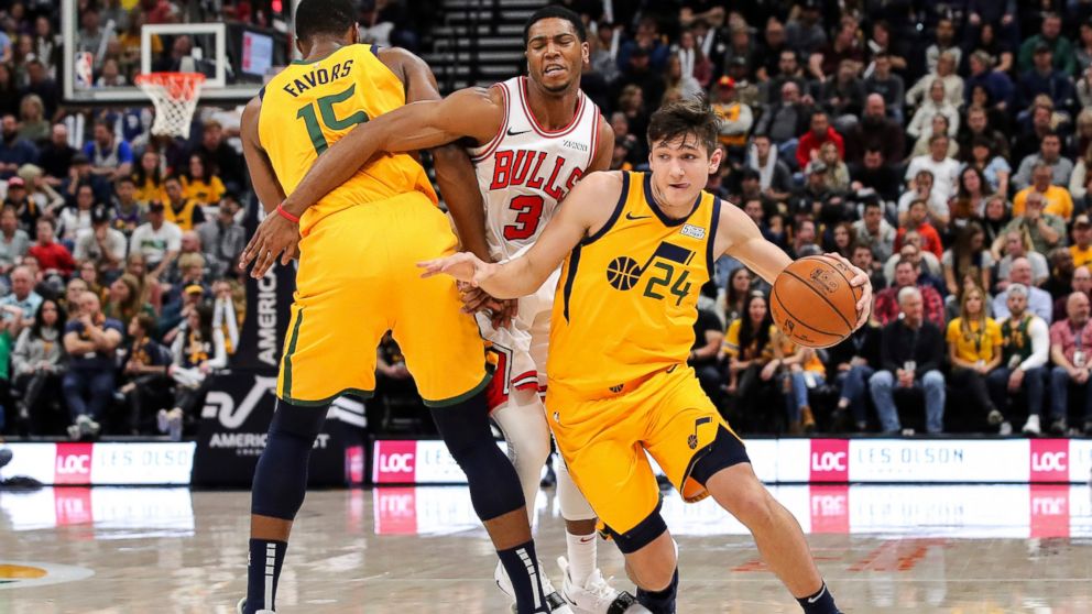 Utah Jazz guard Grayson Allen (24) uses forward Derrick Favors (15) to get away from Chicago Bulls guard Shaquille Harrison (3) during the second quarter of an NBA basketball game Saturday, Jan. 12, 2019, in Salt Lake City. (AP Photo/Chris Nicoll)
