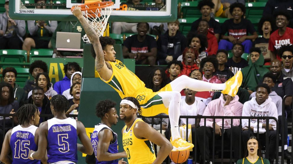 Baylor forward Jalen Bridges dunks over the McNeese State defense in the first half of an NCAA college basketball game, Wednesday, Nov. 23, 2022, in Waco, Texas. (AP Photo/Rod Aydelotte)