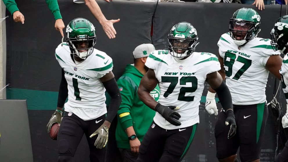 New York Jets cornerback Sauce Gardner (1) celebrates with teammates Micheal Clemons (72) and Nathan Shepherd (97) during the second half of an NFL football game against the Buffalo Bills, Sunday, Nov. 6, 2022, in East Rutherford, N.J. (AP Photo/John
