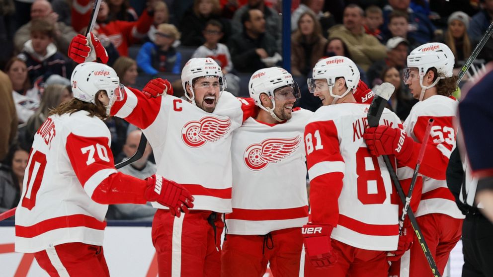 Detroit Red Wings players celebrate their goal against the Columbus Blue Jackets during the first period of an NHL hockey game, Saturday, Nov. 19, 2022, in Columbus, Ohio. (AP Photo/Jay LaPrete)