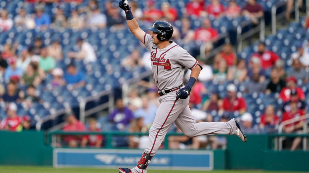 Atlanta Braves' Austin Riley gestures as he rounds the bases after hitting a two-run home run in the first inning of a baseball game against the Washington Nationals, Friday, July 15, 2022, in Washington. (AP Photo/Patrick Semansky)