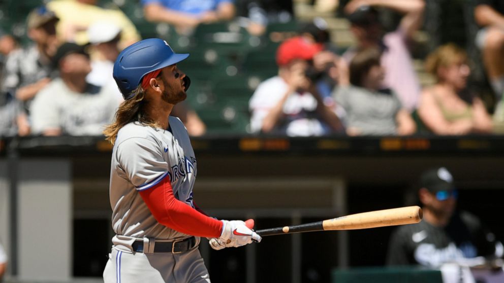 Toronto Blue Jays' Bo Bichette watches his grand slam home run during the fourth inning of a baseball game against the Chicago White Sox, Wednesday, June 22, 2022, in Chicago. (AP Photo/Paul Beaty)