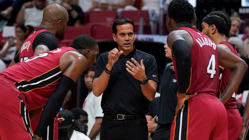 Miami Heat head coach Erik Spoelstra, center, talks with players as officials review a play during the second half of Game 5 of an NBA basketball first-round playoff series against the Atlanta Hawks, Tuesday, April 26, 2022, in Miami. (AP Photo/Wilfr