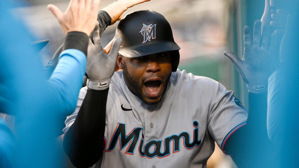 Miami Marlins' Jesus Aguilar celebrates his home run in the dugout during the third inning of a baseball game against the Washington Nationals, Wednesday, April 27, 2022, in Washington. (AP Photo/Nick Wass)