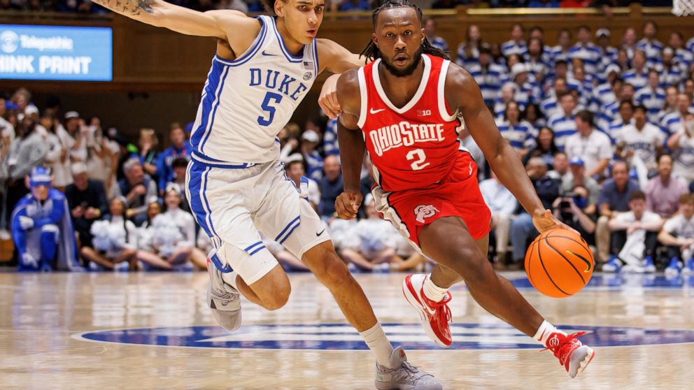 Ohio State's Bruce Thornton (2) handles the ball as Duke's Tyrese Proctor (5) defends during the first half of an NCAA college basketball game in Durham, N.C., Wednesday, Nov. 30, 2022. (AP Photo/Ben McKeown)