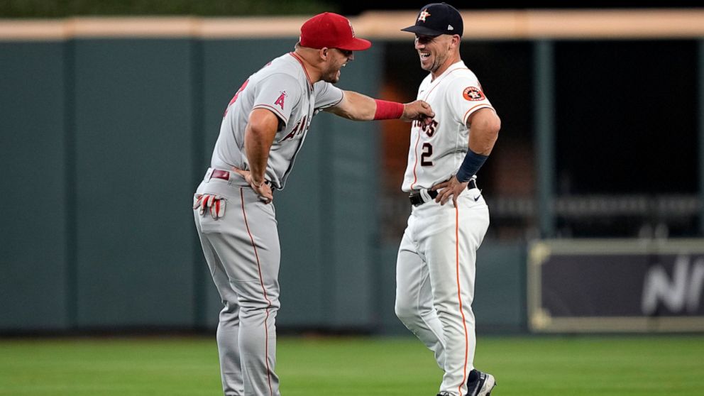 Houston Astros' Alex Bregman (2) talks with Los Angeles Angels' Mike Trout before a baseball game Saturday, July 2, 2022, in Houston. (AP Photo/David J. Phillip)