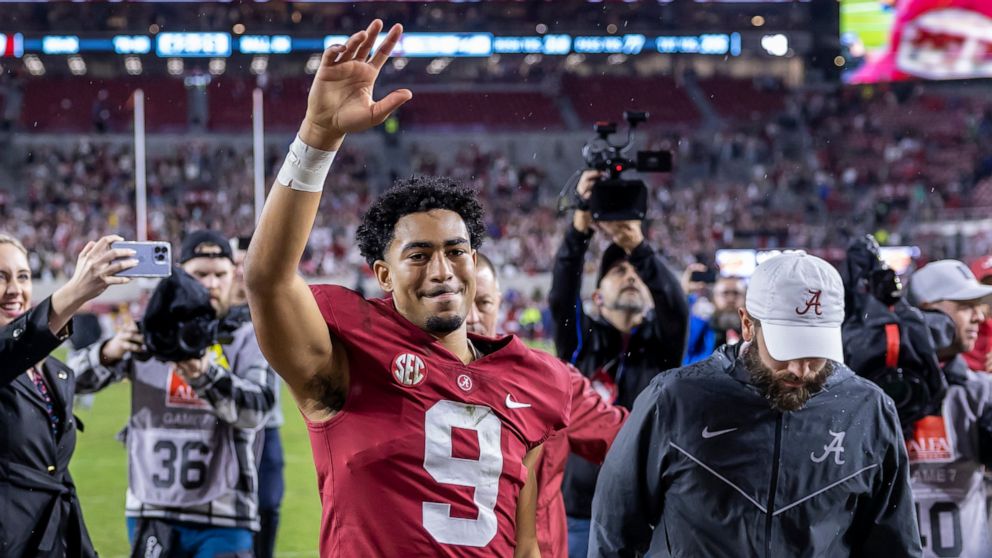 Alabama quarterback Bryce Young (9) salutes the fans as he leaves the field following an NCAA college football game against Auburn, Saturday, Nov. 26, 2022, in Tuscaloosa, Ala. (AP Photo/Vasha Hunt)