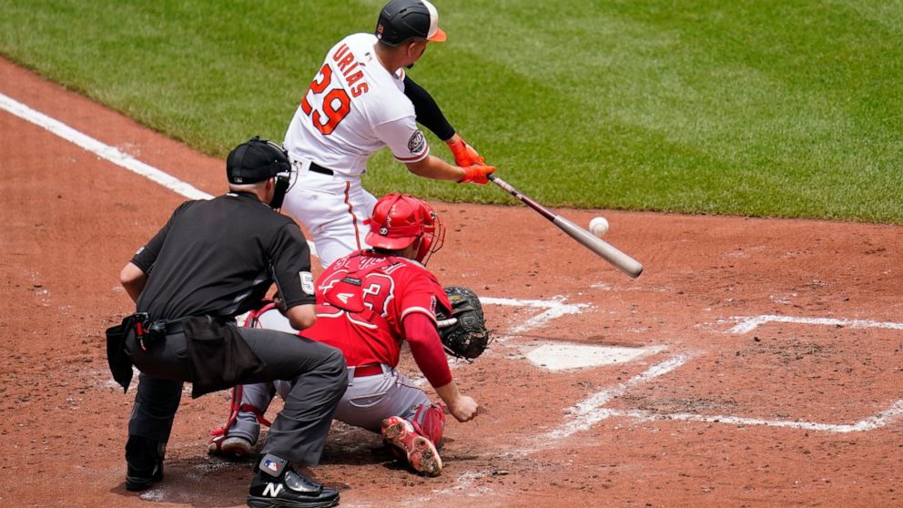 Baltimore Orioles' Ramon Urias (29) connects for a two-run single that drove in Ryan Mountcastle and Anthony Santander during the fourth inning of a baseball game against the Los Angeles Angels, Sunday, July 10, 2022, in Baltimore. (AP Photo/Julio Cortez)