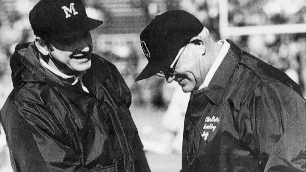 FILE - Michigan football coach Bo Schembechler, left, meets with Ohio State coach Woody Hayes in this file photo, location unknown. No. 2 Ohio State and No. 3 Michigan have a chance to add to The Game lore. If highly anticipated matchup goes as expec