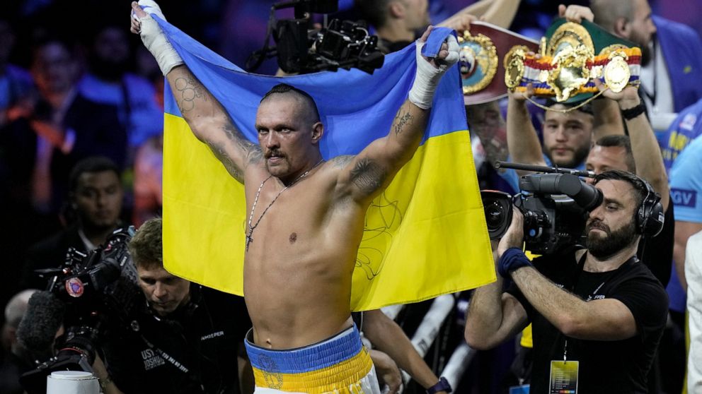 Ukraine's Oleksandr Usyk celebrates after beating Britain's Anthony Joshua to retain his world heavyweight title at King Abdullah Sports City in Jeddah, Saudi Arabia, Sunday, Aug. 21, 2022. (AP Photo/Hassan Ammar)