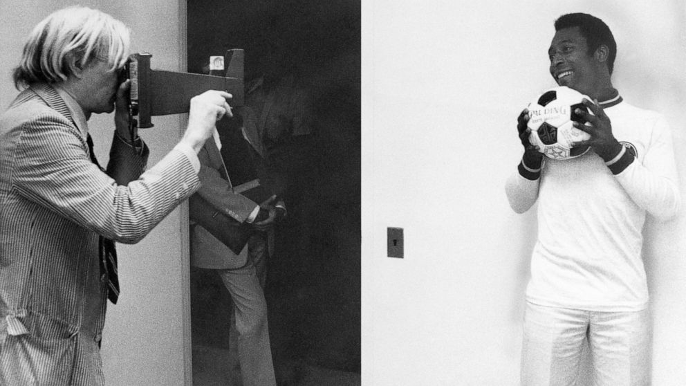 FILE - In this July 27, 1977, file photo, pop artist Andy Warhol, left, makes a photograph of Pele for use in painting a portrait of the soccer superstar in New York. (AP Photo/Claudia Larson, File)