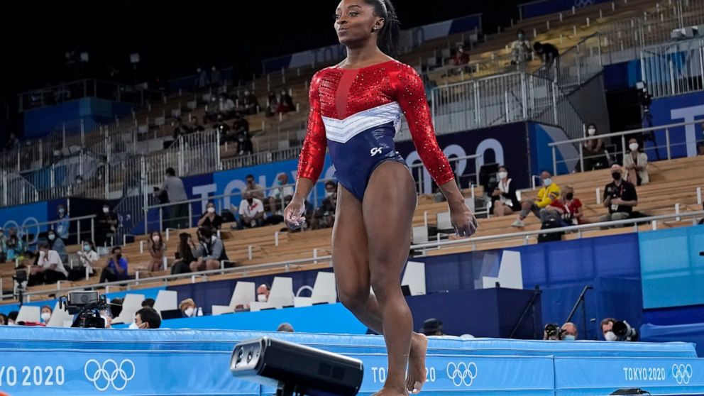 Simone Biles, of the United States, walks after performing on the vault during the artistic gymnastics women's final at the 2020 Summer Olympics, Tuesday, July 27, 2021, in Tokyo. (AP Photo/Ashley Landis)
