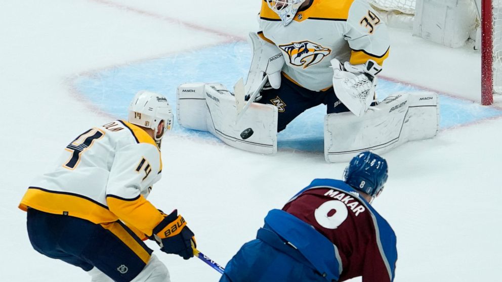 Nashville Predators goaltender Connor Ingram (39) blocks a shot by Colorado Avalanche defenseman Cale Makar, bottom right, during the first period in Game 2 of an NHL hockey Stanley Cup first-round playoff series Thursday, May 5, 2022, in Denver. (AP