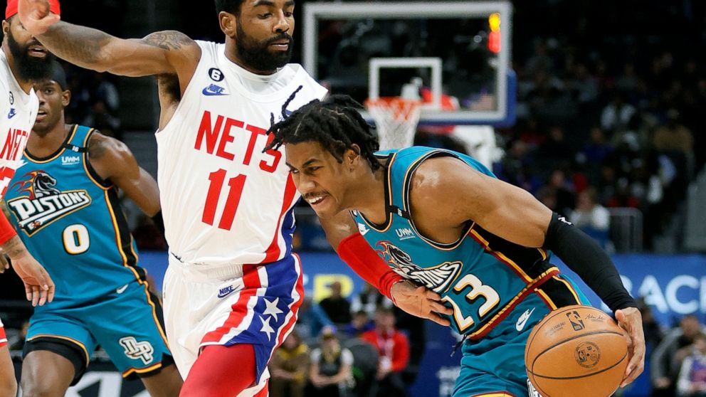 Detroit Pistons guard Jaden Ivey (23) drives against Brooklyn Nets guard Kyrie Irving (11) during the first half of an NBA basketball game Sunday, Dec. 18, 2022, in Detroit. (AP Photo/Duane Burleson)