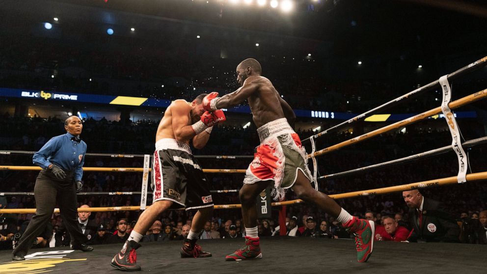 Terence Crawford, right, fights David Avanesyan during a World Boxing Organization welterweight world title boxing match on Saturday, Dec. 10, 2022, in Omaha, Neb. Crawford knocked out Avanesyan in the sixth round. (AP Photo/Rebecca S. Gratz)