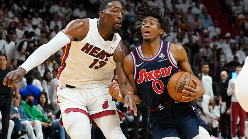 Philadelphia 76ers guard Tyrese Maxey (0) drives to the basket as Miami Heat center Bam Adebayo (13) defends, during the first half of Game 2 of an NBA basketball second-round playoff series, Wednesday, May 4, 2022, in Miami. (AP Photo/Marta Lavandier)