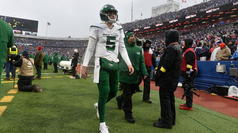 New York Jets quarterback Mike White (5) walks to the locker room during the second half of an NFL football game against the Buffalo Bills, Sunday, Dec. 11, 2022, in Orchard Park, N.Y. As a precaution, Jets head coach Robert Saleh said White was sent