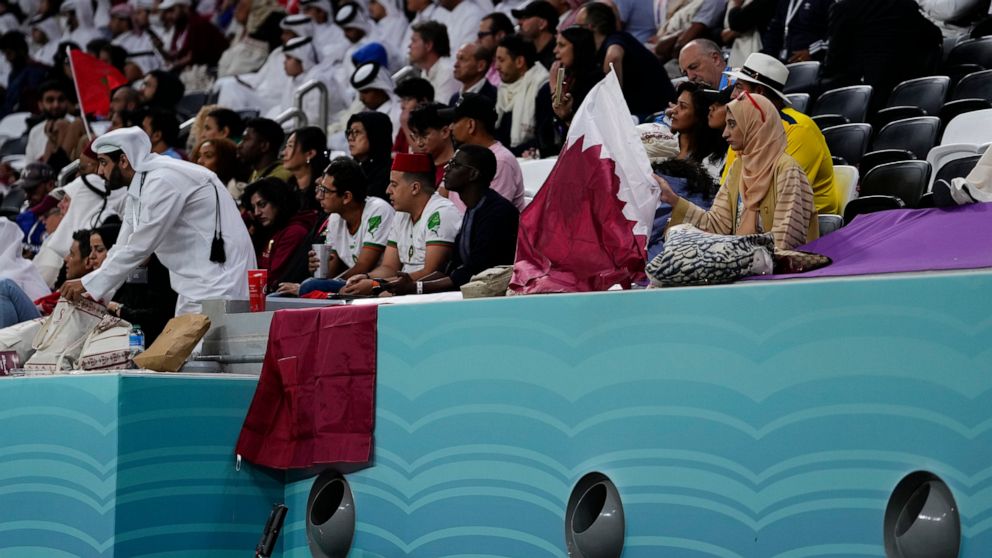 Fans sit on the stands above air conditioning ventilators during a World Cup group A soccer match between Qatar and Ecuador at the Al Bayt Stadium in Al Khor , Qatar, Sunday, Nov. 20, 2022. (AP Photo/Manu Fernandez)