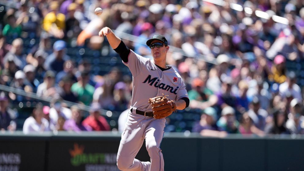 Miami Marlins third baseman Joey Wendle throws to first base to put out Colorado Rockies' Connor Joe in the first inning of a baseball game Monday, May 30, 2022, in Denver. (AP Photo/David Zalubowski)