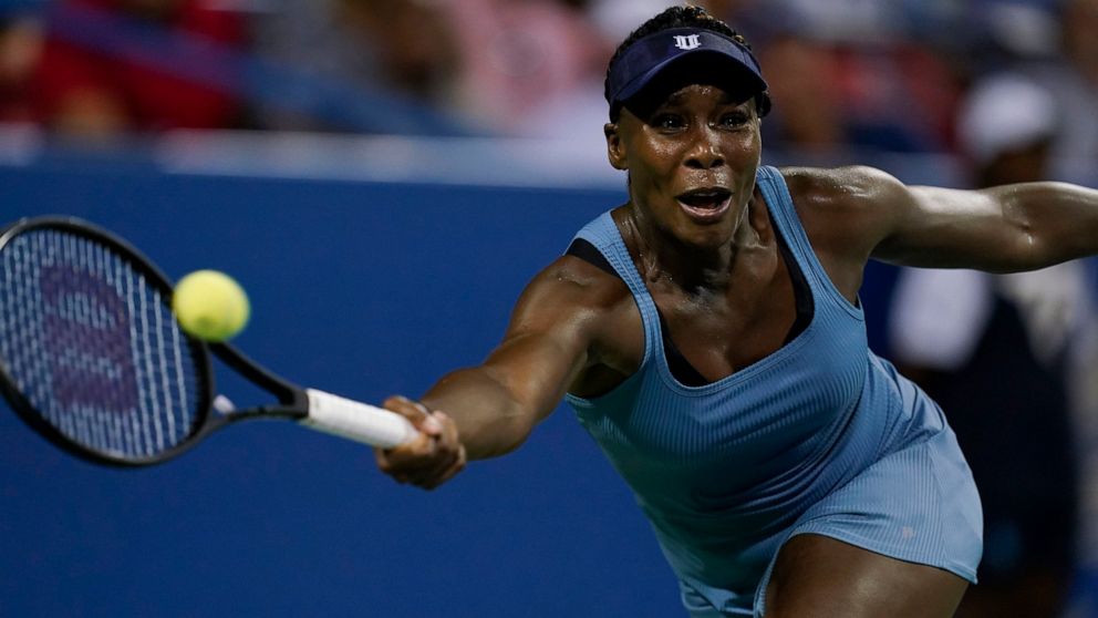Venus Williams, of the United States, returns during a first-round match against Rebecca Marino, of Canada, at the Citi Open tennis tournament in Washington, Monday, Aug. 1, 2022. (AP Photo/Carolyn Kaster)
