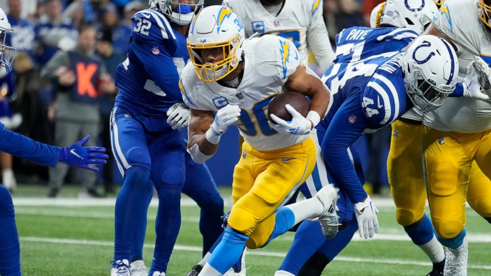 Los Angeles Chargers' Austin Ekeler (30) runs in for a touchdown during the first half of an NFL football game against the Indianapolis Colts, Monday, Dec. 26, 2022, in Indianapolis. (AP Photo/AJ Mast)