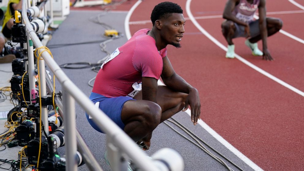 Fred Kerley, of the United States, sits on the track after a heat during the men's 200-meter semifinal run at the World Athletics Championships on Tuesday, July 19, 2022, in Eugene, Ore. (AP Photo/Ashley Landis)