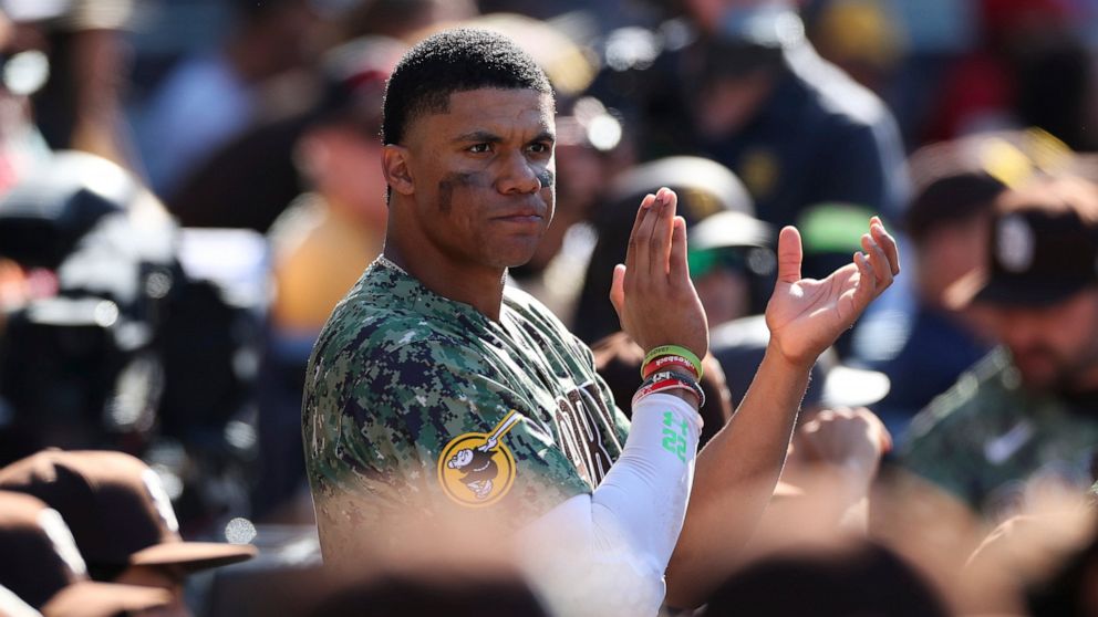 San Diego Padres' Juan Soto claps after the team clinched a playoff spot in the seventh inning of a baseball game against the Chicago White Sox, Sunday, Oct. 2, 2022, in San Diego. (AP Photo/Derrick Tuskan)