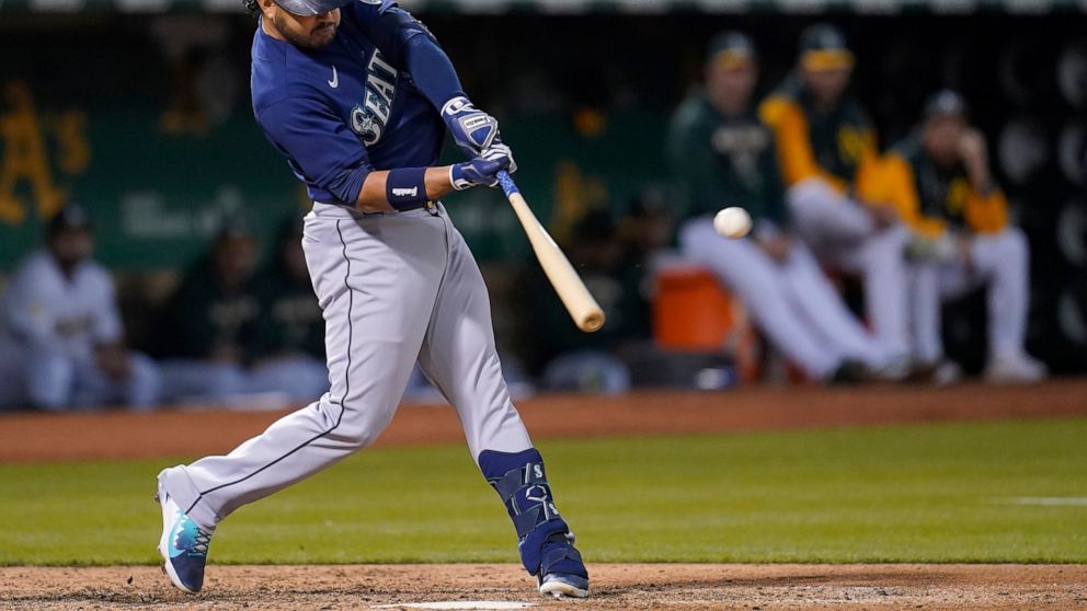 Seattle Mariners' Eugenio Suarez hits a three-run home run against the Oakland Athletics during the sixth inning of a baseball game in Oakland, Calif., Friday, Aug. 19, 2022. (AP Photo/Jeff Chiu)