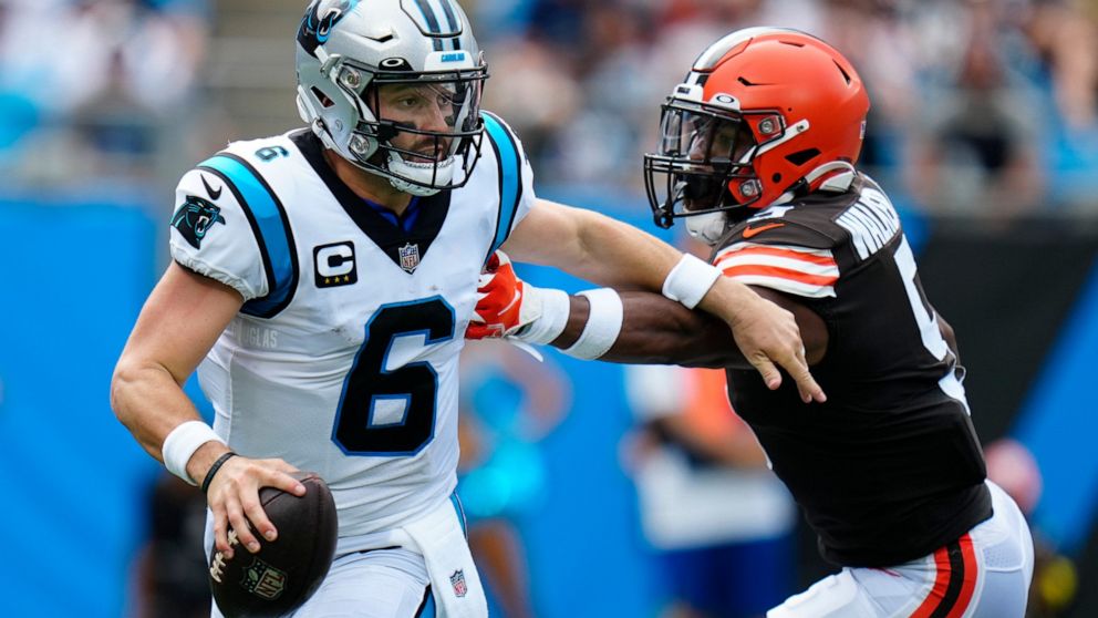 Carolina Panthers quarterback Baker Mayfield looks to pass under pressure from Cleveland Browns linebacker Anthony Walker Jr. during the first half of an NFL football game on Sunday, Sept. 11, 2022, in Charlotte, N.C. (AP Photo/Rusty Jones)