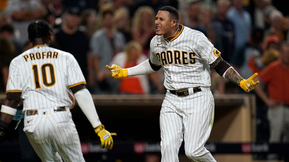 San Diego Padres' Manny Machado, right, celebrates with Jurickson Profar after hitting a three-run home run against the San Francisco Giants during the ninth inning of a baseball game Tuesday, Aug. 9, 2022, in San Diego. (AP Photo/Gregory Bull)