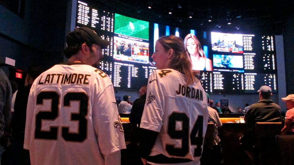 Football fans wait for kickoff in the sports betting lounge at the Ocean Casino Resort on Sept. 9, 2018, in Atlantic City, N.J. On Wednesday, Jan. 6, 2021, New York's governor did an about-face and embraced mobile sports betting as a way to deal with