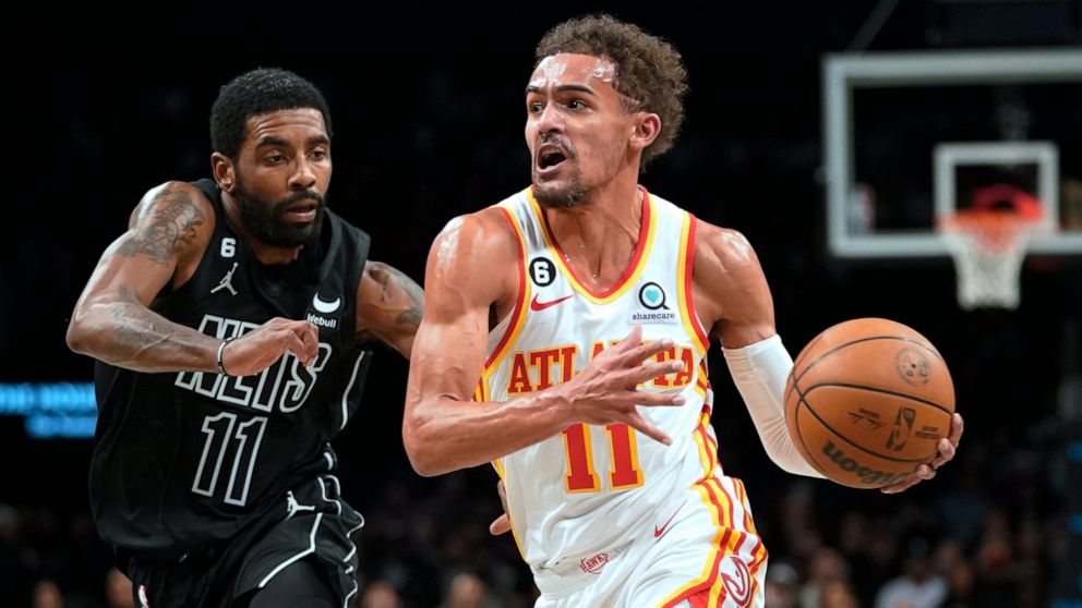 Atlanta Hawks guard Trae Young, right, drives against Brooklyn Nets guard Kyrie Irving during the first half of an NBA basketball game Friday, Dec. 9, 2022, in New York. (AP Photo/Mary Altaffer)