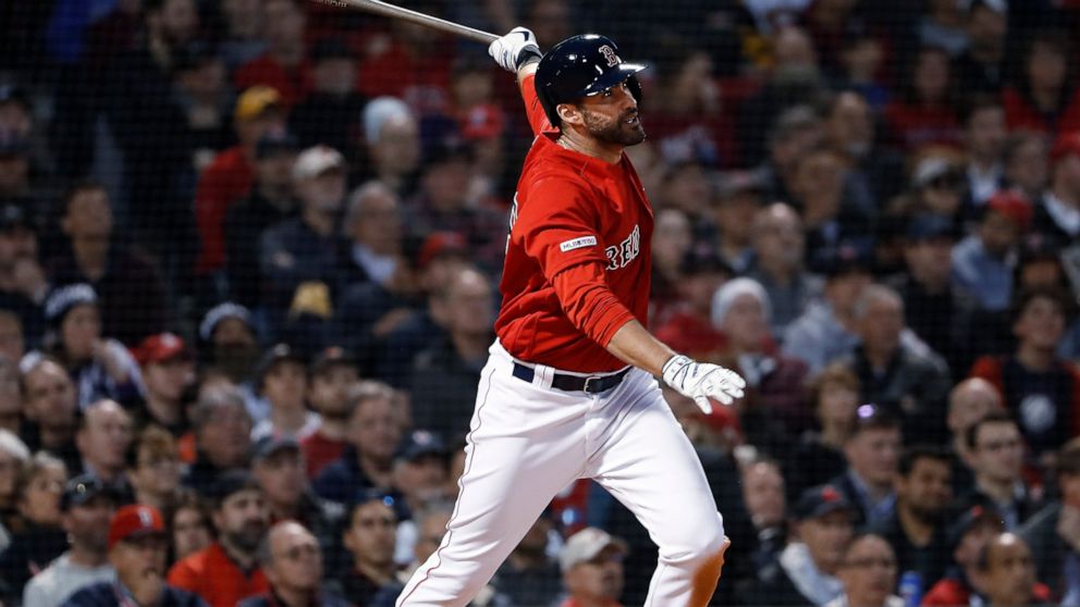 Boston Red Sox's J.D. Martinez follows through on his two-run home run against the Colorado Rockies during the third inning of a baseball game Wednesday, May 15, 2019, at Fenway Park in Boston. (AP Photo/Winslow Townson)