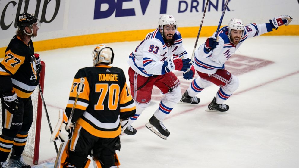 New York Rangers' Mika Zibanejad (93) and Tyler Motte (64) begin the celebrate the winning goal by Chris Kreider (not shown) during the third period in Game 6 of an NHL hockey Stanley Cup first-round playoff series against the Pittsburgh Penguins in 