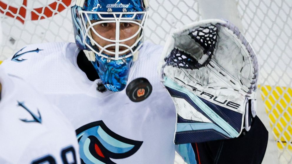 Seattle Kraken goalie Joey Daccord stops a shot during the second period of an NHL hockey game against the Calgary Flames, Tuesday, Nov. 1, 2022 in Calgary, Alberta. (Jeff McIntosh/The Canadian Press via AP)