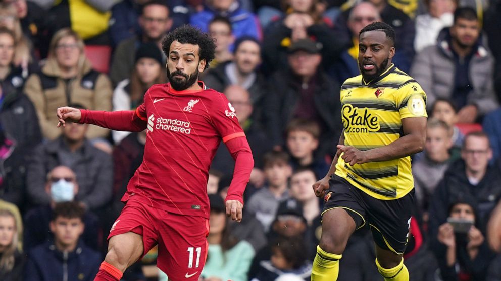 Liverpool's Mohamed Salah, left, and Watford's Danny Rose battle for the ball during the English Premier League soccer match between Watford and Liverpool at Vicarage Road, Watford, England, Saturday, Oct. 16, 2021. (Tess Derry/PA via AP)
