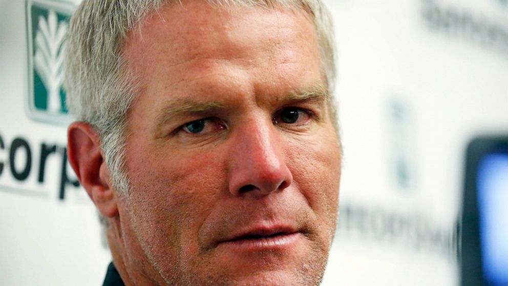 FILE - Former NFL football quarterback Brett Favre speaks with reporters prior to his induction to the Mississippi Hall of Fame in Jackson, Miss., on Aug. 1, 2015. Favre is asking to be removed from a civil lawsuit in Mississippi that seeks to recove