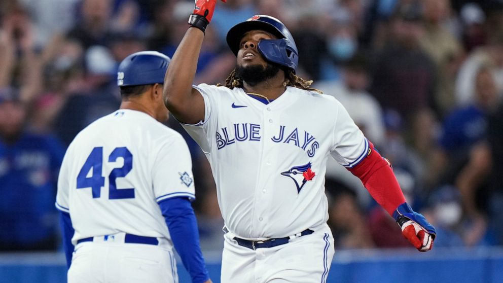 Toronto Blue Jays' Vladimir Guerrero Jr., right, celebrates his solo home run against the Oakland Athletics during the first inning of a baseball game Friday, April 15, 2022, in Toronto. (Frank Gunn/The Canadian Press via AP)