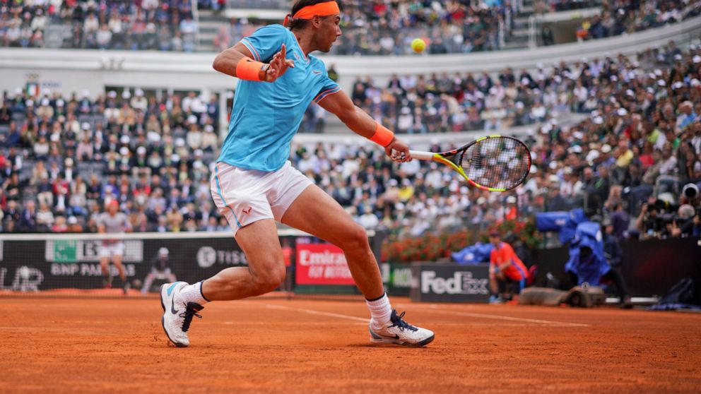 Rafael Nadal of Spain returns the ball to Stefanos Tsitsipas of Greece during a semifinal match at the Italian Open tennis tournament, in Rome, Saturday, May 18, 2019. (AP Photo/Andrew Medichini)