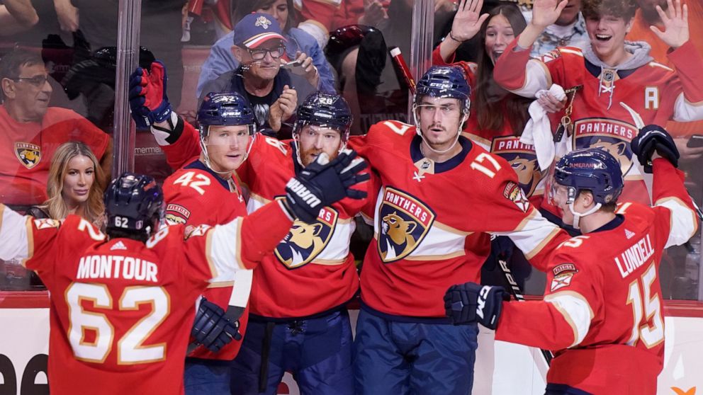 Florida Panthers teammates celebrate a goal by Florida Panthers left wing Mason Marchment (17) during the second period of Game 2 of an NHL hockey first-round playoff series , Thursday, May 5, 2022, in Sunrise, Fla. (AP Photo/Marta Lavandier)