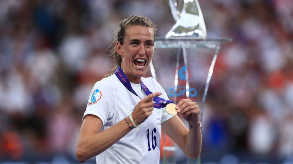 FILE - England midfielder Jill Scott shows her gold medal after the Women's Euro 2022 final soccer match between England and Germany at Wembley stadium in London, July 31, 2022. Scott announced her retirement from soccer on Tuesday, Aug. 23, 2022, th