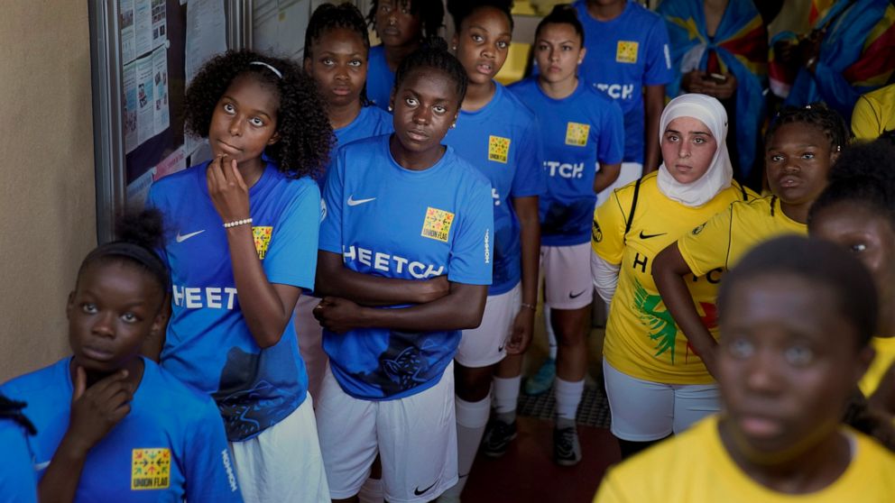 Players wait before entering the field prior to the final women's game of the national cup of working-class neighborhoods betwwen a team representing players with Malian heritage against one with Congolese roots, in Creteil, outside Paris, France, Sa