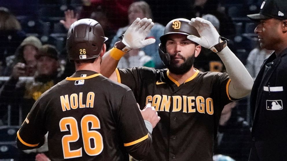 San Diego Padres' Austin Nola (26) and Eric Hosmer celebrate after scoring on a Trayce Thompson hit to left field during the sixth inning of a baseball game against the Pittsburgh Pirates, Friday, April 29, 2022, in Pittsburgh. (AP Photo/Keith Srakocic)