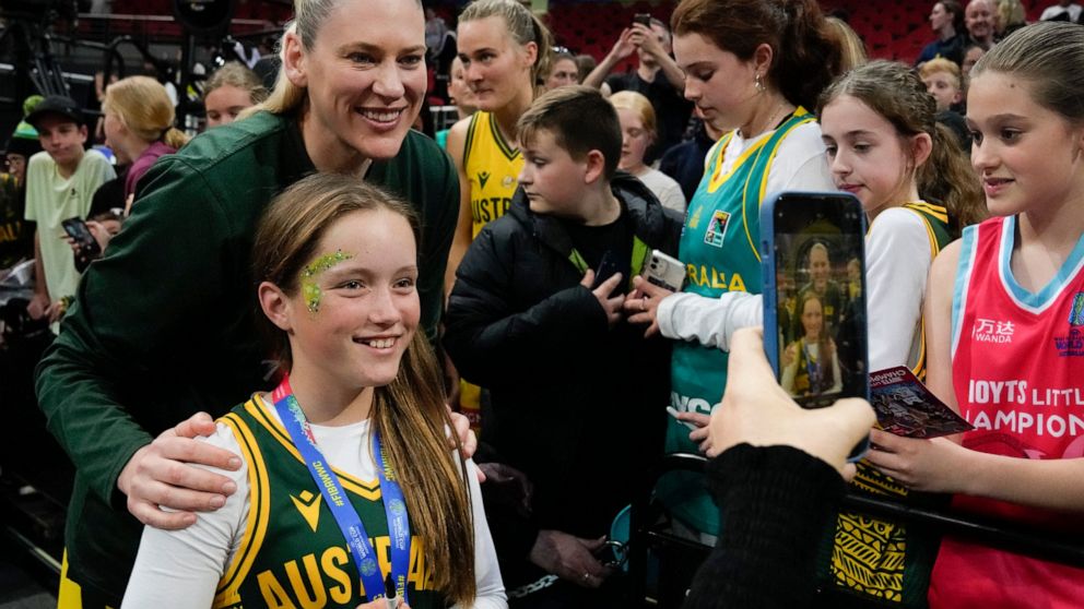 Australia's Lauren Jackson poses for a selfie with a young fan following their win over Japan at the women's Basketball World Cup in Sydney, Australia, Tuesday, Sept. 27, 2022. (AP Photo/Mark Baker)