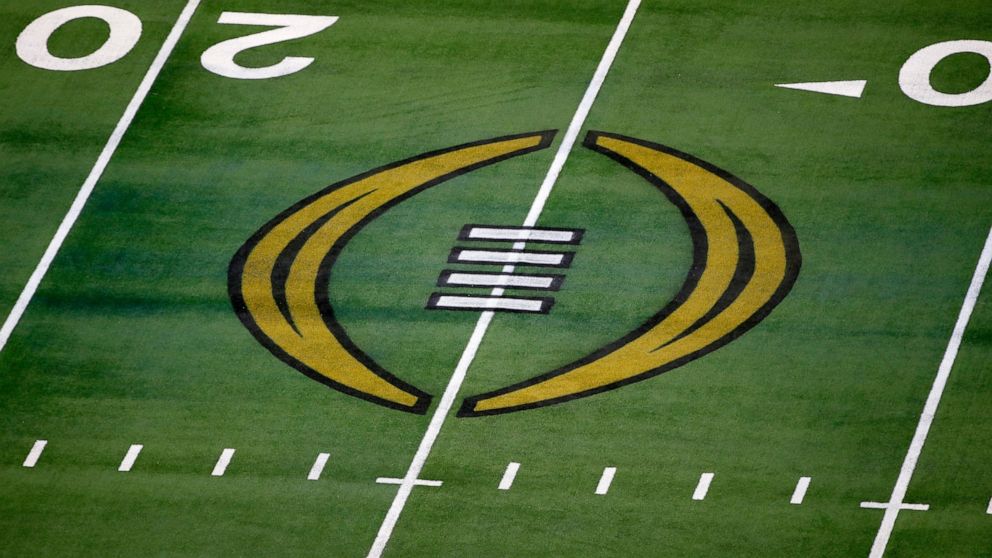 FILE - The College Football Playoff logo is shown on the field at AT&T Stadium before the Rose Bowl NCAA college football game between Notre Dame and Alabama in Arlington, Texas, Jan. 1, 2021. The College Football Playoff announced Thursday, Dec. 1, 