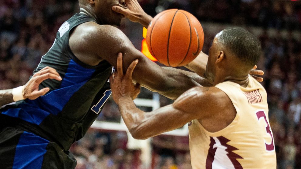 Florida State guard Trent Forrest, right, gets his hand in the face of Duke forward Zion Williamson forcing a turnover in the first half of an NCAA college basketball game in Tallahassee, Fla., Saturday, Jan. 12, 2019. (AP Photo/Mark Wallheiser)