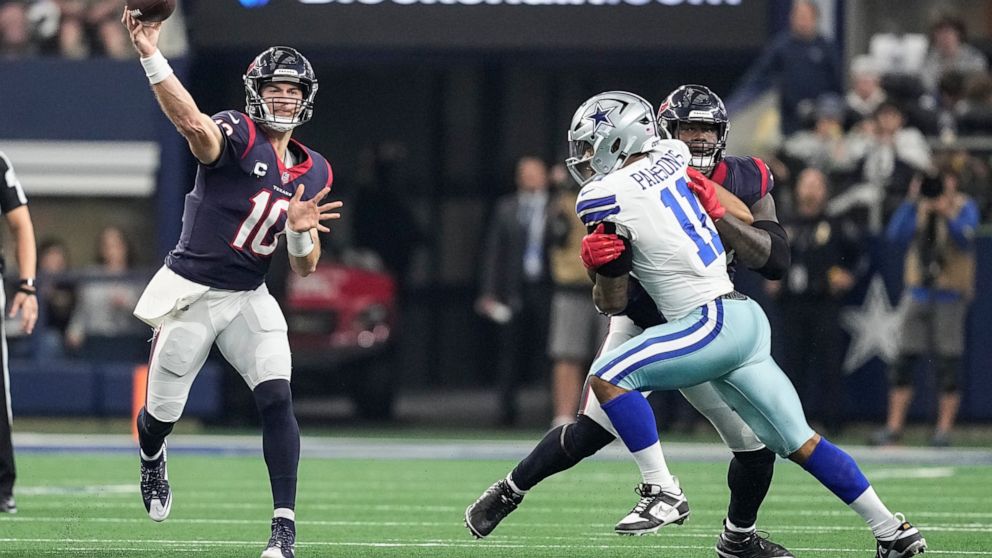 Houston Texans quarterback Davis Mills (10) throws a pass under pressure from Dallas Cowboys linebacker Micah Parsons (11) during the first half of an NFL football game, Sunday, Dec. 11, 2022, in Arlington, Texas. (AP Photo/Tony Gutierrez)