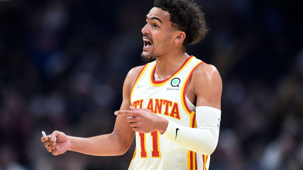 Atlanta Hawks guard Trae Young reacts to a foul call during the first half of the team's NBA play-in basketball game against the Cleveland Cavaliers on Friday, April 15, 2022, in Cleveland. (AP Photo/Nick Cammett)