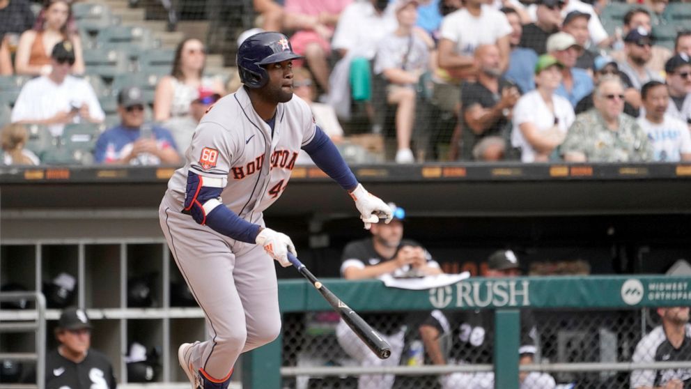 Houston Astros' Yordan Alvarez watches his RBI double off Chicago White Sox relief pitcher Vince Velasquez, scoring Jose Altuve, during the fourth inning of a baseball game Thursday, Aug. 18, 2022, in Chicago. (AP Photo/Charles Rex Arbogast)