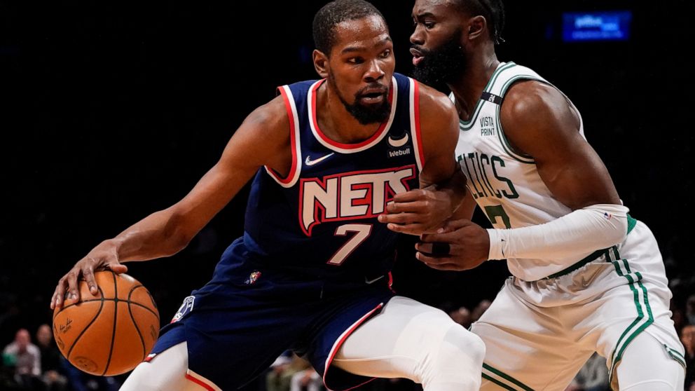 FILE - Brooklyn Nets forward Kevin Durant (7) drives against Boston Celtics guard Jaylen Brown, right, during the first half of Game 4 of an NBA basketball first-round playoff series April 25, 2022, in New York. Durant has again told Nets owner Joe T